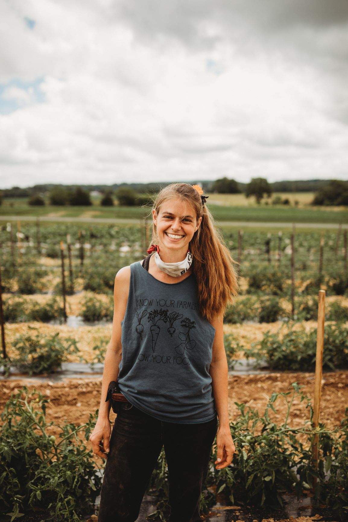 emma w tomatoes in field